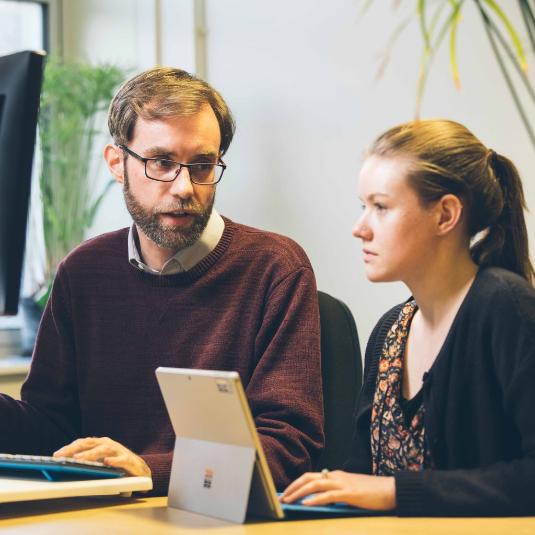 Librarian and library user working together